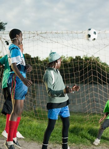 Teenage boys playing football